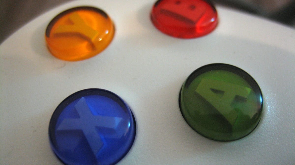 Macro close-up of colourful game controller face buttons